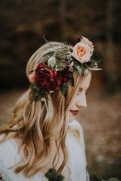 a woman with long blonde hair wearing a flower crown