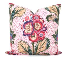 a pink pillow with colorful flowers on it