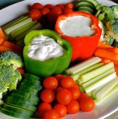 a white plate topped with veggies and dip