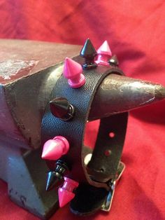 "This pink and black spiked bracelet is made with real 3/4\" wide leather. The cuff is adjustable and is secured with a 3/4\" wide buckle. These fun, 1/2\" painted spikes are screwed on tightly to the leather band. Other spiky bracelets and collars are available. Please check my other listings. https://www.etsy.com/shop/rowansoriginals?section_id=10200537" Spiky Bracelets, Spike Bracelet, Leather Collar, Leather Cuffs, Pink And Black, Leather Band, Houston Tx, Dream Closet, Cuff Bracelets