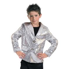 a young boy in a silver jacket and black shirt standing with his hands on his hips