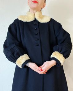 "Shearling Chic. Stunning Vintage 1940's jet black wool coat with 2 piece raglan lantern sleeves, 6 gore panel back, carved glass buttons and shearling trim. So warm, so chic, a chefs kiss so to speak.  Fits S/M/L (I'm about a M), but please use measurements as fit guide.  21\" bust (on the half)  23.5\" waist (on the half)  26.5\" hip (on the half)  28\" sleeve from neckline  43.5\" length  Fully lined  Wool  Center front carved glass button closures Raglan 2pc lantern sleeves with seaming details, gathering and shearling trim at cuffs  Front welt pockets  Shearling collar  Shoulder darts  6 gore panel back with seaming details at mid back  Excellent vintage condition (small pocket lining seam repair, buttons have been replaced by me)" Vintage Long Coat For Costumes, Vintage Fitted Wool Coat For Winter, Vintage Black Long Sleeve Outerwear For Winter, Classic Black Costume Outerwear, Vintage Winter Outerwear With Button Cuffs, Vintage Outerwear In Vintage Black For Winter, Vintage Black Winter Outerwear, Classic Vintage Black Winter Outerwear, Formal Vintage Outerwear With Faux Fur Trim