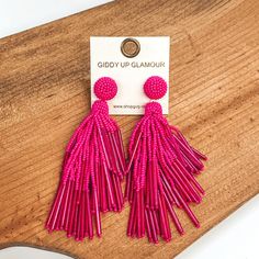 Circle beaded stud earrings with a beaded tassel in hot pink. These earrings are pictured laying on a brown piece of wood on a white background. Giddy Up Glamour, New And Improved, Beaded Dangle Earrings, Tassel Earrings, In Hot, Tassel Necklace, Tassels, Hot Pink, Night Out