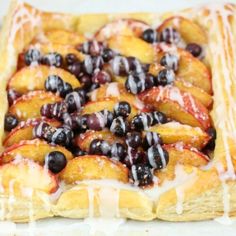 a pastry with blueberries and cream on it