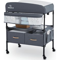 a baby changing table with two drawers and a basket on it's bottom shelf