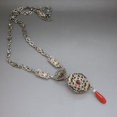 A stunning, unique quality handcrafted Austrian Biedermeier style bib collier necklace with genuine untreated Mediterranean red coral and natural seed pearls set in openwork 835 silver. Elaborate 1930's artisan silverwork, eternal classics. The necklace will be shipped in a gift box. A unique gift idea for a special occasion! Necklace length: 16 1/2 inch / 42 cm - measured excluding the bib part Bib central piece measures 3 inches long by 1 inch wide (7.5 cm x 2.5 cm) Necklace weight: 31.4 grams Antique Evening Necklace With Intricate Design, Antique Red Necklace For Wedding, Vintage Necklaces With Intricate Design For Evening, Antique Red Necklace With Large Pendant, Vintage Pendant Necklace With Historical Design, Red Medallion Necklace For Formal Occasions, Victorian Large Pendant Necklace For Weddings, Elegant Red Necklace With Large Pendant, Victorian Wedding Necklace With Large Pendant