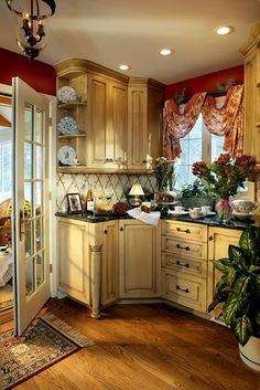 a large kitchen with wooden cabinets and lots of counter space, including a potted plant