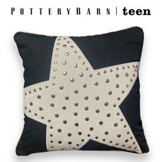 a black and white pillow with a star design on the front, along with text that reads pottery barn teen