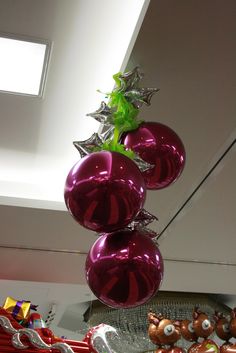 christmas decorations hanging from the ceiling in a room