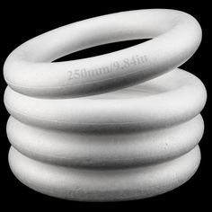 three white coiled hoses sitting on top of each other in front of a black background