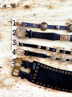 Vintage Concho Belt Fossil Southwestern wide Skinny shaped Silver Blue Black M L ....CHOOSE ONE (of 5) Vintage belts 1. Handmade, Blue Leather, Silver hook, studs scallop concho 30x 5/8", 13" chain charm, $48  2. Fossil, shaped Black leather, Silver Concho, 36.5x1 3/8", 6 holes; 28-33", M, $68 3.Silver Buckle stays, Black Leather, silver studs rings, 43x 1/2", 6 holes: 38-42", $68 4.Silver Buckle/stay, topstitch Black Skinny, Vegan, Silver slides, 43.5x 3/4", 7 holes: 33-39", $48 5.Wide Belt, 2 Brass buckles rivets, Black, 36.5x 3 7/8", 6 holes: 39-44", $128   >  SHOP GREEN @ greenmarketvintage.etsy.com Concho Belt, Vintage Belts, Brass Buckle, Suspender Belt, Wide Belt, Leather Silver, Black Skinnies, Silver Blue, Rivets