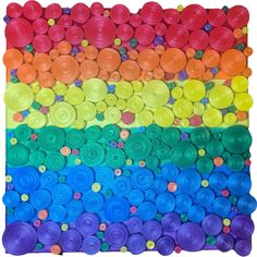 an art project made out of yarn and plastic buttons on a white background with rainbow colors