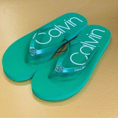 This Is Giving Off Some Serious Emerald Green Vibes From The Wizard Of Oz. Such A Great Pair Of Sandals To Take To The Beach Or Pair With Some Crisp White Jeans To Elevate The Occasion! Brand New And Without Tags. Calvin Klein Green Slipper Flip Flops Women’s Size 10 A001 Trendy Green Flip Flops For Beach Season, Green Slip-on Flip Flops For Beach Season, Trendy Green Flat Flip Flops, Green Flat Summer Flip Flops, Calvin Klein Slip-on Sandals For Summer, Calvin Klein Casual Sandals With Cushioned Footbed, Casual Calvin Klein Sandals With Cushioned Footbed, Green Open Toe Flip Flops For Beach Season, Calvin Klein Casual Slip-on Sandals