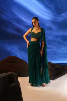 Feel like a Queen, draped in Jade's Celia saree. Showcasing exceptional embroidery in tone-on-tone rich emerald green hue, the blouse features a queen anne neckline and is paired with a side slit drape saree and embroidered pallu. Colour Emerald Green Hand Embroidery Crepe- Blouse Georgette-Saree Dry Clean 2 Components 3-4 weeks delivery Emerald Green Indian Outfit, Party Wear Western Dresses, Indian Reception Outfit, Color Verde Esmeralda, Green Evening Gowns, Queen Anne Neckline, Anniversary Dress, Simple Lehenga, Saree Wearing Styles