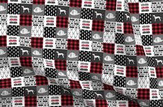 a black and white checkered fabric with red, gray and white designs on it