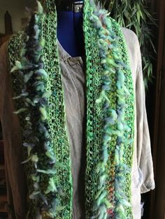 Colorful, fun and funky. Cottons, nylon, ribbon and acrylics. An assortment of greens, with two rows of fuzzy fiber giving this scarf alot of fun texture. There are slight rust/orange accents giving it a soft pop of contrast color. My scarfs are made to be enjoyed wearing to work, out in the evenings, and are boutique quality, fun wearable pieces to be enjoyed for years. 80" long and 6."' wide. Hand wash in cold water, dry flat. Winter Green Yarn Scarves, Green Yarn Scarves For Winter, Green Winter Scarves One Size, Green Scarves For Winter, Green Bohemian Scarf For Fall, Handmade Green Winter Scarves, Handmade Green Winter Scarf, Handmade Green Scarf For Winter, Green Bohemian Scarf One Size