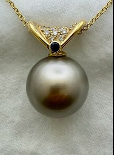 Tahitian black pearl pendant 14 kt. yellow gold, o.17 ct. TW. diamonds, o.o5 ct. sapphire. Pearl-14.7 mm. Chain not included. Fun Objects, Black Pearl Pendant, Tahitian Pearl Pendant, Luck Spells, Black Pearls, Tahitian Black Pearls, Tahitian Pearls, Pendant Gold, Black Pearl