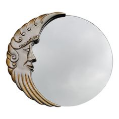 a mirror that has a woman's face on the moon in front of it