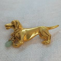 Vintage mid-century c1960s dachshund dog brooch in goldtone metal. It is in excellent condition and even has a small nephrite jade charm on the collar! This cutie measures approximately 2 inches from nose to tail and 1" tall. Jade Charm, Dachshund Art, Dog Brooch, Nephrite Jade, Mid Century Vintage, Dachshund Dog, Animal Jewelry, Dog Lover, Dachshund