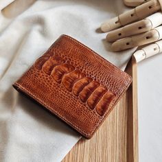 Men's leather Alligator bifold wallet  Thank you for your trust in ordering from us. We appreciate your expressions of appreciation and are especially grateful for the recent wallet order. Hope that our products will bring good luck to you. Thank you for choosing our store to supply your needs. We look forward to sharing your success. 1) Product Description: Dimensions: approx. 115mm x 90mm Color: Brow Material: Outer - Alligator Leather Interior - Epsom Leather Made in Vietnam. 2) Shipping and handling: - We will send through the shipping unit of the shipping enterprises in Vietnam. - After receiving your order, we will take 5 to 7 days to process the product and then ship it to you. - It will take 10-20 days to arrive - Contact us if you need a faster delivery service - Orders placed ove Leather Bifold Wallet With Crocodile Pattern, Bifold Wallet With Crocodile Pattern For Gift, Bifold Wallet With Crocodile Pattern As Gift, Crocodile Pattern Bifold Wallet As A Gift, Luxury Brown Trifold Wallet As Gift, Luxury Brown Trifold Wallet Gift, Gifts For Him Birthday, Birthday Gifts For Men, Good Luck To You