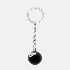 a key chain with a black ball hanging from it