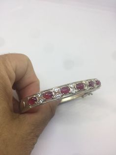 This genuine White sapphire frames bright red Rubies bracelet is very lively and bright. The stones are deep colors and well matched. The sterling silver is plated with rhodium to protect the bracelet from tarnish All jewelry is shipped in a nice gift box. Check out our over a THOUSAND great reviews Engraving is $4 per letter and is not always perfect depending on the piece. It can take a few days if the jeweler is busy. This is payable to Paypal Judithsltd@gmail.com Elegant Red Polished Gemstones, Oval Gemstone Bangle For Formal Events, Oval Gemstone Bangle In Fine Jewelry Style, Round Ruby Bracelet For Formal Occasions, White Gold Multi-stone Ruby Jewelry, White Gold Ruby Multi-stone Jewelry, Luxury Red Oval Bracelet, Luxury Ruby Bangle Gift, Luxury Ruby Bangle For Gift