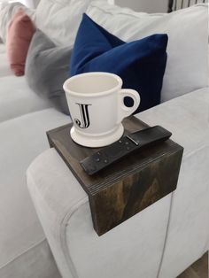 a white coffee cup sitting on top of a wooden table