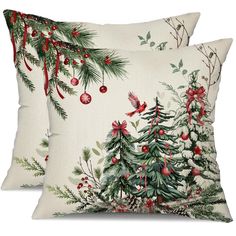 two pillows with christmas decorations on them and one has a red bird sitting on the tree