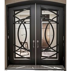 an ornate black double door with glass panels