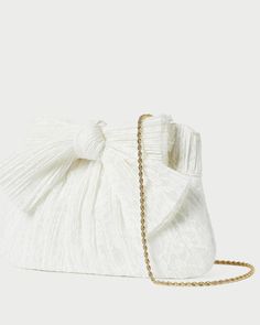 Pleated frame clutch in white fabric covered with cream lace and topped with our signature knotted bow. Features a removable twisted gold chain crossbody strap, frame closure, full lining, and gold stamped logo. Elegant Wedding Bags With Bow, Elegant Wedding Bags With Bow Detail, Chic White Evening Bag, Elegant Bags With Bow For Events, Chic Cream Evening Bag, Chic White Clutch Evening Bag, Elegant Beige Bag With Bow, Chic Formal Cream Evening Bag, Chic Cream Evening Bag For Formal Occasions