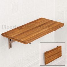 a wooden table sitting on top of a white wall next to a pair of legs