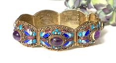 "Lovely and glamorous antique* Chinese Export gold gilt over sterling silver filigree panel link bracelet, enamel details and amethyst cabochon bracelet made in China exclusively for export to the west some time between 1920 and 1948 (judging from the hallmark as well as the wirework visible on both sides). This bracelet features seven panels each with an oval shaped amethyst cabochon surrounded by intricate filigree and ornate butterfly themed enamel. Excellent condition for a century old piece Antique Gold Enamel Bracelets, Traditional Purple Jewelry For Formal Occasions, Antique Jeweled Jewelry For Formal Occasions, Antique Enamel Bracelet For Formal Occasions, Antique Enamel Bracelets For Formal Occasions, Vintage Gold Enamel Bracelets, Art Deco Enamel Jewelry For Formal Occasions, Antique Formal Jewelry, Antique Jeweled Bangle