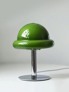 a green lamp sitting on top of a table