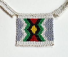 Charming old vintage Native American glass beadwork necklace Length: 1-7/8" Height: 1-5/8" Necklace length: 14-1/2" Good vintage condition with minor wear NOTE: Please bear in mind that, when you purchase vintage , it might not be perfect, but it will be authentic.  No returns will be accepted on vintage items so make sure that you read the description and look at the pictures before committing to a purchase. Please contact me if you have additional questions about the nature and condition of the product. Artisan White Beaded Chain, White Artisan Beaded Necklaces With Beaded Chain, Artisan White Beaded Chain Necklace, White Artisan Beaded Necklace With Beaded Chain, Traditional Beaded Rectangular Necklaces, Traditional Beaded Rectangular Necklace, Traditional Rectangular Beaded Necklace, Handmade Traditional Rectangular Necklace, Traditional Handmade Rectangular Necklace