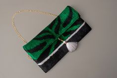 Emerald and Black Clutch purse ---Customized Order Ikat fabrics are produced entirely by the hand-woven method. After the patterns on it are dyed, the weaving begins and is completed in a long time. The patterns are not prints. and it is completely handmade. 🔔 Pattern: Abtract 🔔 Color: Emerald and Black 🔔 Size: 6.7 x 11.8  inches  15x30 cm 🔔 Care: Dry clean only 🔔 Closure: Magnetic 🔔 Exterior Gunmetal hardware  Interwoven chain  Magnetic closure  2023 production  🔔 Interior Cream fabric interior Two compartments  One zip pocket  🔔 Special order We can realize the design you have in mind for the ikat fabric you want. You can order bags in any shape you want from the fabrics on our page. I am waiting for your messages for this. We care about our business and you. We accept immediate Handmade Green Rectangular Evening Bag, Green Rectangular Evening Bag With Removable Pouch, Green Rectangular Clutch As Gift, Elegant Green Pouch For Everyday Use, Elegant Green Pouch For Everyday, Green Rectangular Clutch Gift, Green Rectangular Clutch For Gift, Rectangular Green Clutch For Gift, Elegant Green Envelope Clutch