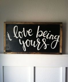 a wooden sign that says i love being your's