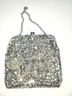 Absolutely gorgeous 60s Du-Val designer silver evening clutch purse with a kiss lock. The purse was made in Hong Kong and is highly decorated with beads and sequin with a beautiful flower beaded in the middle of the bag. The chain and the kiss lock are silver tone, the lining of the bag is silk satin. The bag has never been used before and is in mint condition. The bag will definitely match your evening dress and will also make a beautiful gift! For more items in my store visit: https://www.etsy Retro Rectangular Coin Purse For Evening, Vintage Silver Rectangular Clutch, Vintage Rectangular Evening Bag For Party, Vintage Embellished Clutch For Party, Vintage Silver Clutch As Gift, Vintage Handmade Evening Bag For Party, Vintage Silver Rectangular Coin Purse, Vintage Silver Clutch As A Gift, Silver Rectangular Evening Bag For Vintage Events