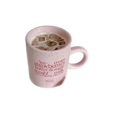 a pink coffee mug filled with ice and some type of drink on top of it