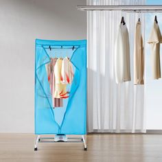 a blue garment rack with clothes hanging on it