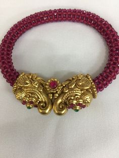 A new addition to our product line by our artisans. A beautiful piece for our traditional Indian Bride! Notice the gorgeous carving work on the twin elephant figure at the center and the red-colored beaded mesh at the base. Material: Brass and copper mix, gold plated, beads The bracelet is the same as shown in the picture and in the video. We have only one piece in this design and color and hence you get what you see in the picture. For wrist sizes 2.4- 2.6 Easily openable with a screw. Red Temple Necklace For Festive Rituals, Red Temple Necklace For Rituals And Festivals, Red Temple Necklace For Rituals And Festive Occasions, Red Beaded Temple Necklace For Festivals, Festive Red Beaded Temple Necklace, Traditional Red Temple Necklace For Festive Occasions, Red Motif Jewelry For Rituals, Red Motifs Jewelry For Rituals, Red Jewelry With Motifs For Rituals