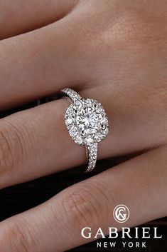 a woman's hand with a diamond ring on top of her finger and the words gabril new york written below it