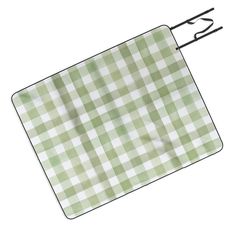 a green and white checkered placemat with a black metal hook on the side