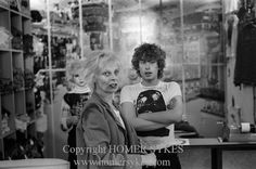 black and white photograph of two women in a clothing store