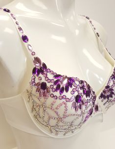 Beautifully hand decorated beaded push up bra in ivory combination decorated with purple gems in assorted colors and sequins. *Individually hand decorated. *Perfect for any occasion. *Lightweight, very comfortable to wear. *Floral design decoration. *Available in multiple US sizes. *2 hooks-eye position at the back for better fitting. *Adjustable shoulder straps. *Free USPS First Class shipping within the US. Shipping upgrade available. *Items located in the US meaning fast order processing/hand Belly Dance Bra Design, Bra Decorating Ideas, Decorated Bras, Bra Ideas, Bra Art, Belly Dance Bra, Bead Bra, Diy Bra, Rhinestone Bra