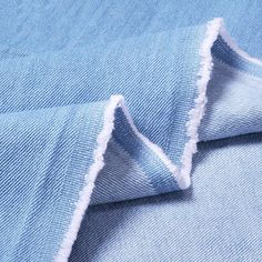 a blue fabric with fraying on it