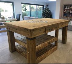 a kitchen island made out of wooden pallets in front of a living room with sliding glass doors