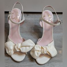 Ted Baker Heevia Moire Satin Bow Heeled Sandals Sz 39/Us9 New And Never Worn, But Was In A Bin With Other Dark Color Shoes. Has Some Small Marks Feminine Summer Wedding Shoes With 4-inch Heel, Feminine Heels With Removable Insole And Round Toe, Beige Open Toe Heels With Bow, Chic Wedding Shoes With Heel Strap And Round Toe, Cream Heels With Heel Strap And Round Toe, Chic Round Toe Wedding Sandals, Feminine Cream Heels With Round Toe, Spring Wedding High Heel Shoes With Removable Insole, Chic Summer Wedding Shoes Medium Width