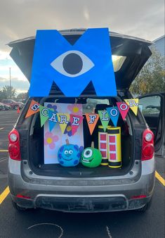 the back end of a car with decorations on it and an evil eye sign in the trunk