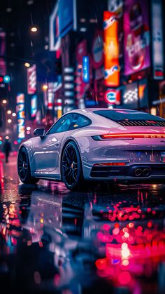 a white sports car parked in the rain at night