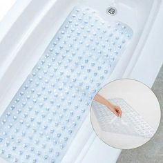 the bathtub mat is being used to clean it's water and drain holes